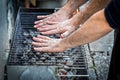 Hands are testing the barbecue heat on charcoal briquettes BBQ. Royalty Free Stock Photo