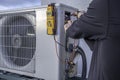Hands testing voltage on a mini split Royalty Free Stock Photo