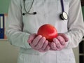 Hands of therapist doctor hold red fresh ripe apple Royalty Free Stock Photo