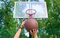 Hands throwing basketball ball into basket Royalty Free Stock Photo