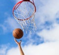 Hands throwing basketball ball into basket Royalty Free Stock Photo