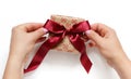 Hands tie a ribbon bow on anEcru gift box Royalty Free Stock Photo