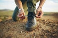 Hands, tie shoes and hiking in nature for travel, training or adventure outdoor. Fitness, sports and person tying laces