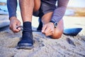 Hands tie shoes, ocean and athlete start workout, training and kayak exercise outdoor. Sand, person and tying sneakers