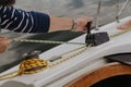 Hands tighten  green rope on yacht Royalty Free Stock Photo