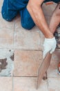 The hands of the tiler are laying the ceramic tile on the floor, selective focus Royalty Free Stock Photo