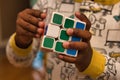 Hands of toddler in Pajamas solving white RubikÃ¢â¬â¢s cube