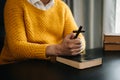 Hands together in prayer to God along with the bible In the Christian concept and religion, woman pray in the Bible on the wooden Royalty Free Stock Photo