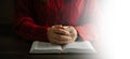 Hands together in prayer to God along with the bible In the Christian concept and religion, woman pray in the Bible on the wooden Royalty Free Stock Photo