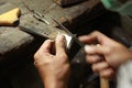 hands and tools of a professional silversmith working on a piece in his traditional workshop, Northern Thailand Royalty Free Stock Photo