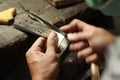 hands and tools of a professional silversmith working on a piece in his traditional workshop, Northern Thailand Royalty Free Stock Photo