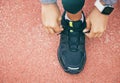 Hands, top view and woman tie shoes at running track, stadium or arena outdoors. Sports, training and black female Royalty Free Stock Photo