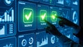 Hands interacting with a futuristic digital screen displaying validated checkmarks and data charts Royalty Free Stock Photo