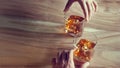 Hands touch whisky bourbon glasses on a grunge wooden backgrou Royalty Free Stock Photo