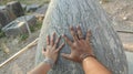 Hands touching Sacred Omphalos Stone