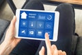 Hands touching smart home automation assistant screen on tablet, interior Royalty Free Stock Photo