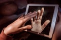 Hands touching through a tablet Royalty Free Stock Photo