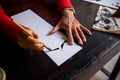 Hands of traditional calligrapher in Hoi An