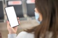 Hands traveler using smartphone mobile in the airport lounge. Blank screen cell phone with space for copy at the airport. woman Royalty Free Stock Photo