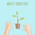 Hands try to holding young plant with Happy Earth Day text, paper cut style Ecology and Earth day concept Royalty Free Stock Photo