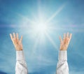 Hands trying to reach on the sky with sunshine rays Royalty Free Stock Photo