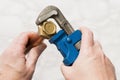 Hands Turning a Brass Nut Using a Pipe Wrench Royalty Free Stock Photo
