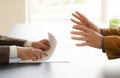 Hands from two businessmen in conversation by a desk. Negotiating business or a job interview. - Image