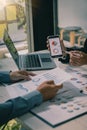 Hands of two businessmen holding pens analyzing charts, financial graphs and accounting documents. The information displayed calcu Royalty Free Stock Photo