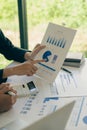 Hands of two businessmen holding pens analyzing charts, financial graphs and accounting documents. The information displayed calcu Royalty Free Stock Photo