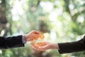 Hands of two businessmen are trading coin of ethereum. A symbolic coins of ethereum. electronic money exchange, Royalty Free Stock Photo