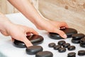 Hands of two masseurs takes spa stones Royalty Free Stock Photo