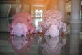 Hands of two muslim woman on the reflection floor praying in traditional clothes