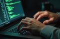 Hands type code on laptop keyboard in dim workspace. Laptop screen displays programming codes. Software development, coding, Royalty Free Stock Photo