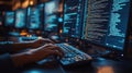 Hands type on keyboard. Person codes on computer. Night time. Focus on person typing. Multiple screens showing code. Tech