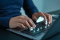 Hands typing on a laptop with cloud computing and networking icons for data transfer and connection Royalty Free Stock Photo