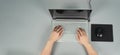 Hands is typing on computer laptop or notebook with mouse and pad on grey background. Studio shot. top eye view Royalty Free Stock Photo