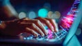Hands typing on a glowing laptop keyboard with code lines and city lights behind Royalty Free Stock Photo