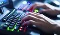 Hands typing on illuminated keyboard, gaming or coding dark room Royalty Free Stock Photo