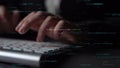 Hands typing on keyboard with abstract digital code and programming text, showcasing technology, computing, and coding Royalty Free Stock Photo