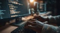 Hands Typing on Keyboard While Coding in a Dimly Lit Workspace With Computer Screens Displaying Programming Scripts Royalty Free Stock Photo
