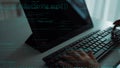 Hands Typing on a Keyboard with Coding Text on a Screen in a Modern Workspace Setting, Symbolizing Programming and Royalty Free Stock Photo