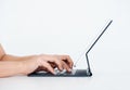 Hands typing on keyboard computer on digital tablet screen on standing isolated on white background. Royalty Free Stock Photo