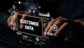 Hands Typing on Keyboard with Digital Interface Showing Customer Data Analysis and Visualization Concepts. Asymptotic Royalty Free Stock Photo