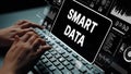 Hands Typing on Keyboard with Digital Screen Displaying Smart Data Concept and Analytics Graphics. Asymptotic smart data Royalty Free Stock Photo