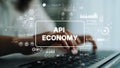 Hands Typing on Keyboard with Overlay of Digital Graphics Representing API Economy and Data Analytics Concepts Royalty Free Stock Photo