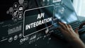 Hands Typing on Keyboard with Overlay Graphics Displaying API Integration and Data Connectivity Concepts in a Modern Royalty Free Stock Photo