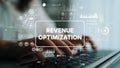 Hands Typing on Keyboard with Revenue Optimization Graphics and Digital Data Overlays in Office Environment. Asymptotic Royalty Free Stock Photo