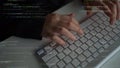 Hands Typing on Keyboard Surrounded by Overlay Code and Programming Elements in Modern Workspace xenic Royalty Free Stock Photo