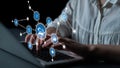 Hands typing on laptop with digital icons representing technology, communication, and data analysis in a modern Royalty Free Stock Photo