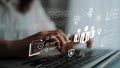Hands typing on a laptop with digital interface displaying technology symbols, data charts, and security icons Royalty Free Stock Photo